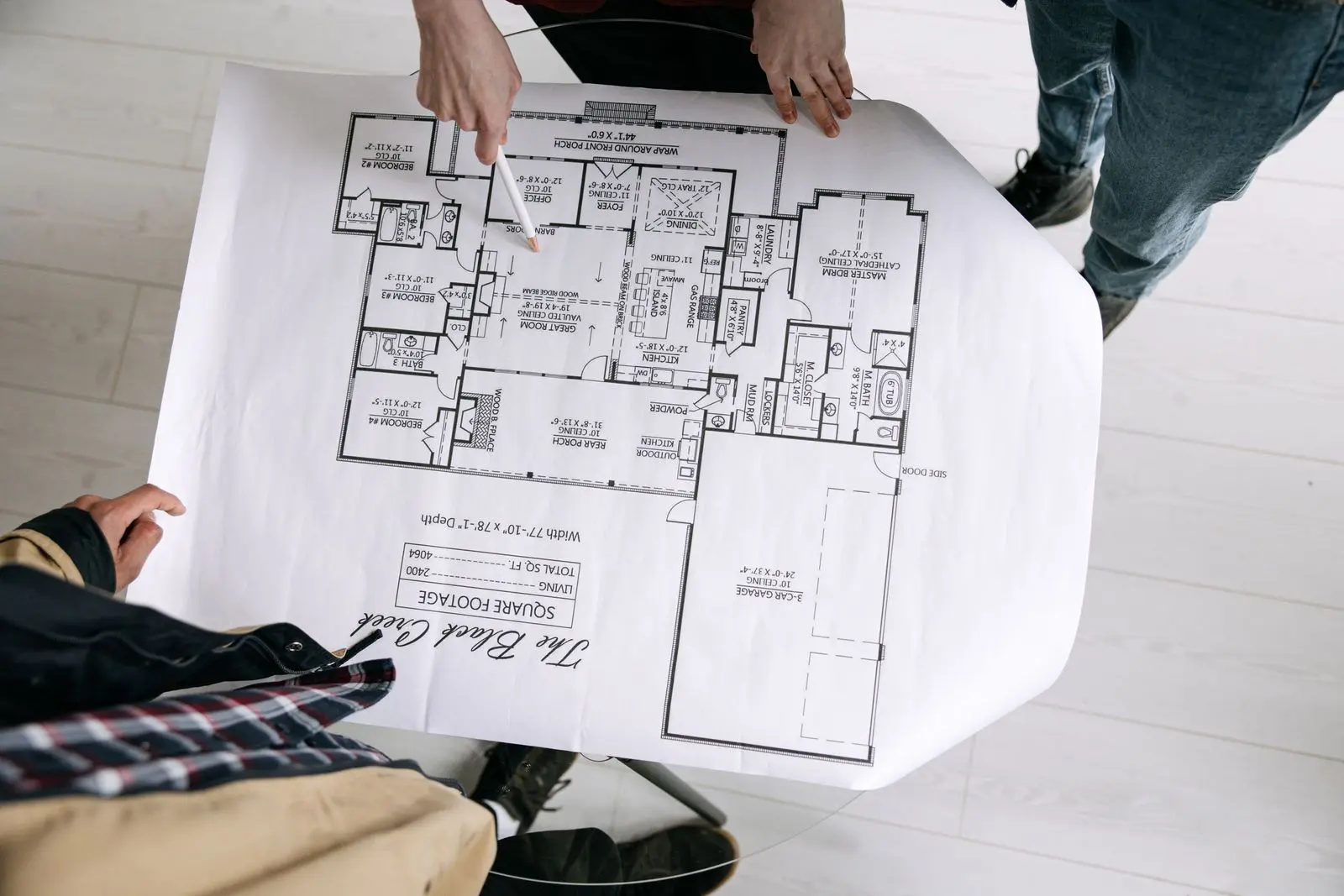Builder and architect examining a floor plan during pre-construction coordination