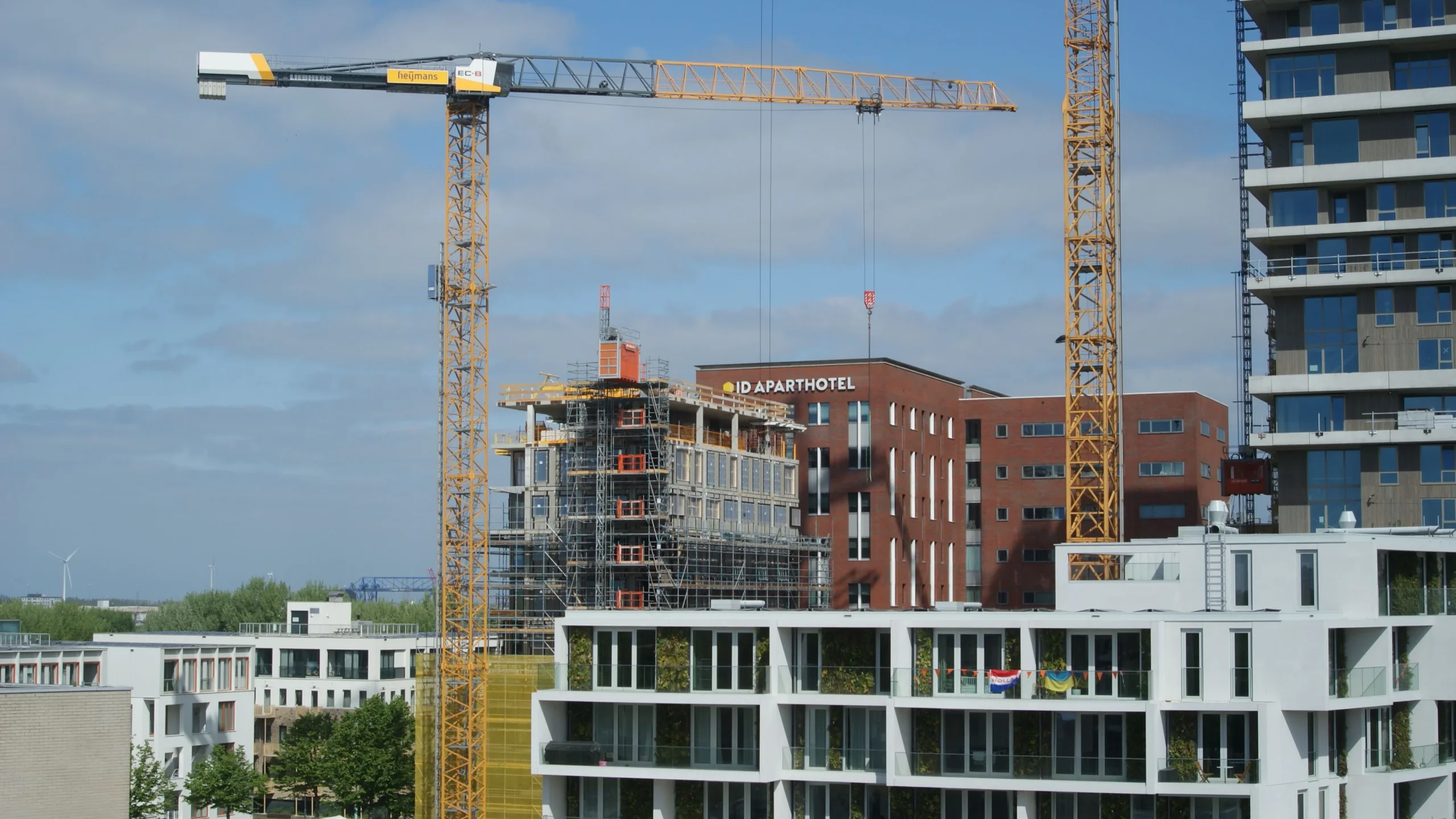 Tower cranes over an apartment construction site, the delivery programme a funding render has to be tied to