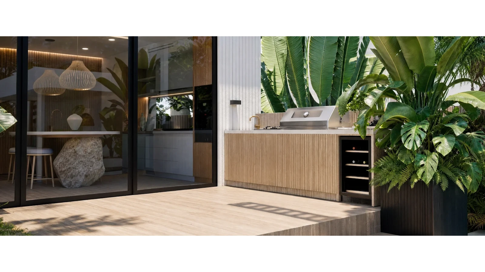Alfresco design outdoor kitchen and bar opening to timber decking and planting