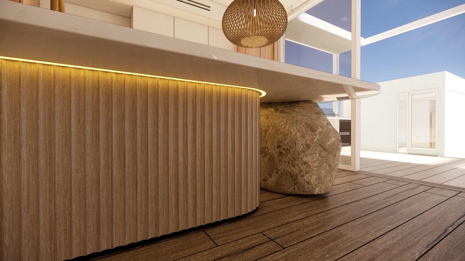 Kitchen island with fluted timber joinery, warm concealed lighting and a sculpted rock base