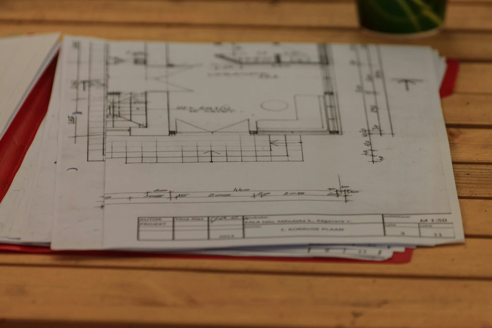 Architectural plans spread across a working desk