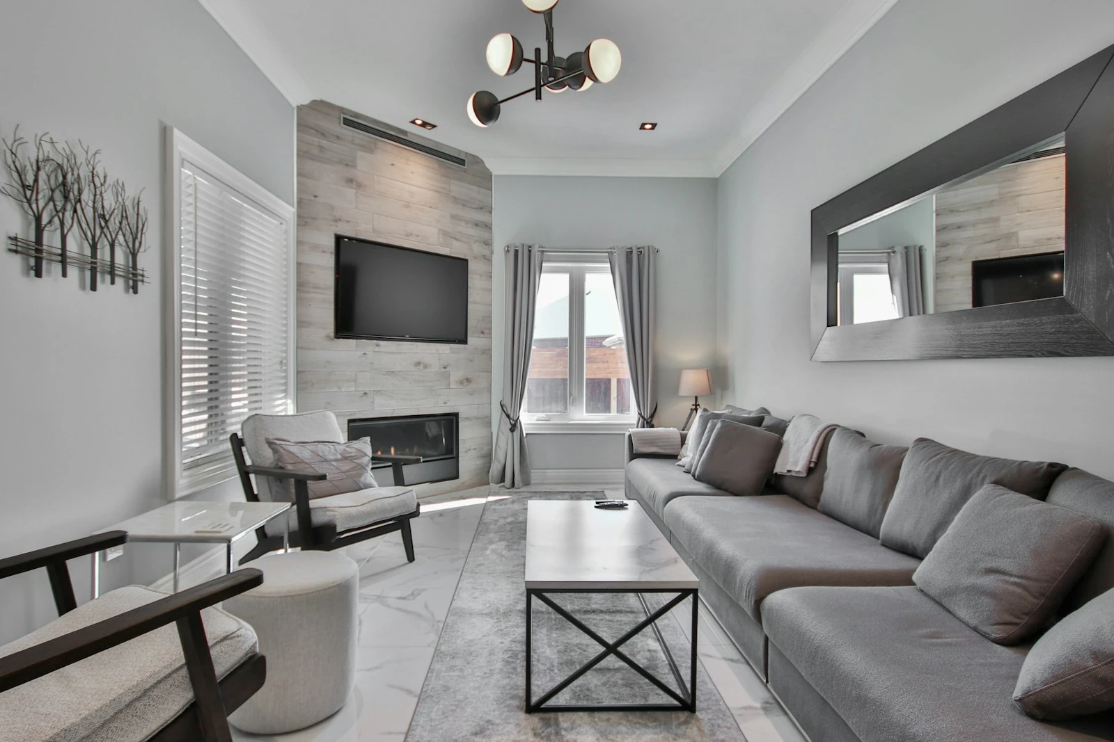 Formal living room with a chandelier and stone detailing