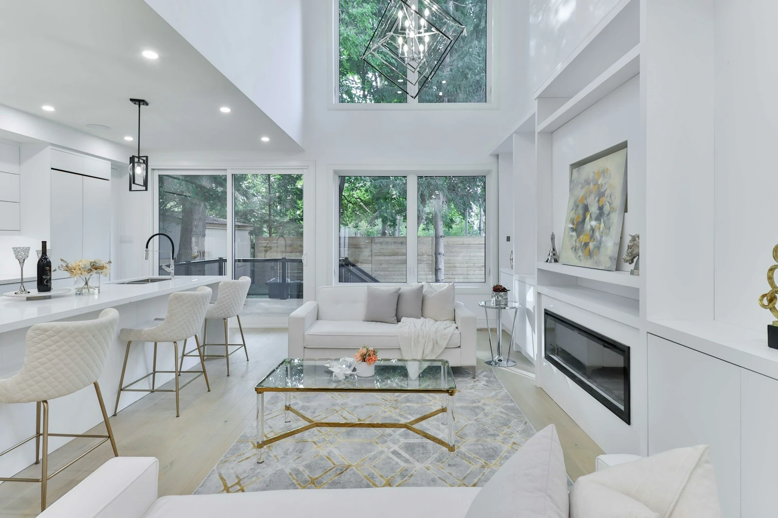 Light filled living and kitchen space in white and timber