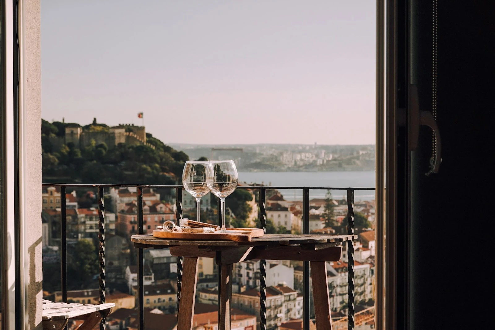 Apartment balcony with seating and an open city outlook