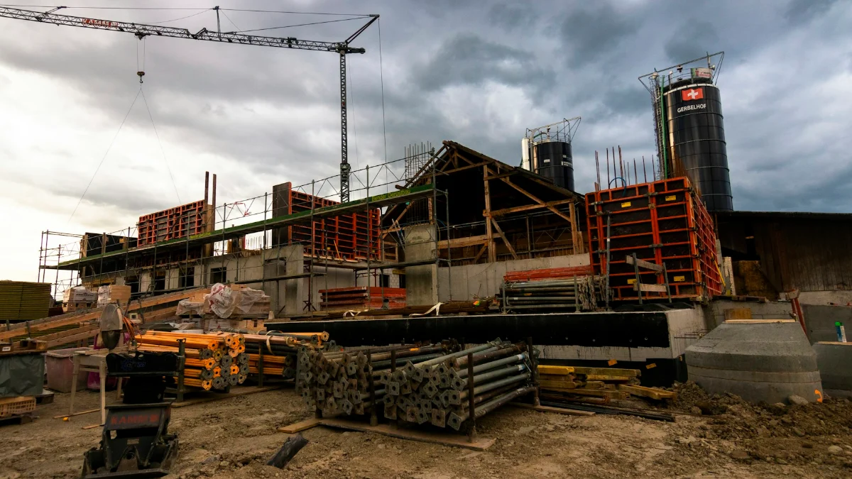 Construction site with a tower crane marking progress against programme
