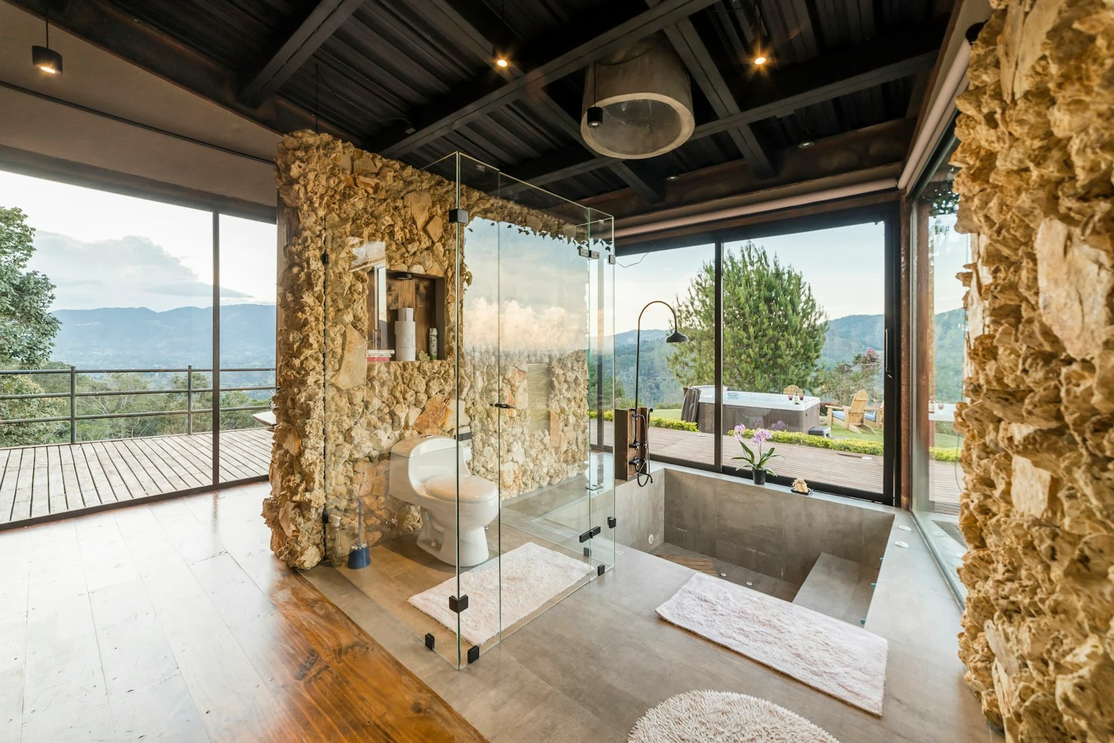Stone bathroom opening to a landscaped outlook