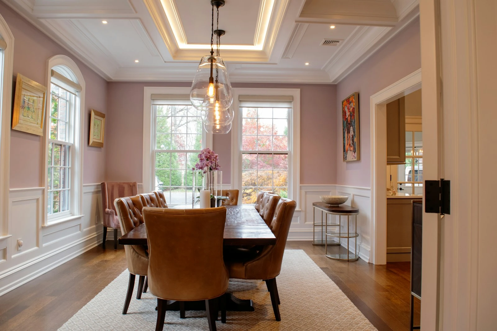 Formal dining room set beneath warm lighting
