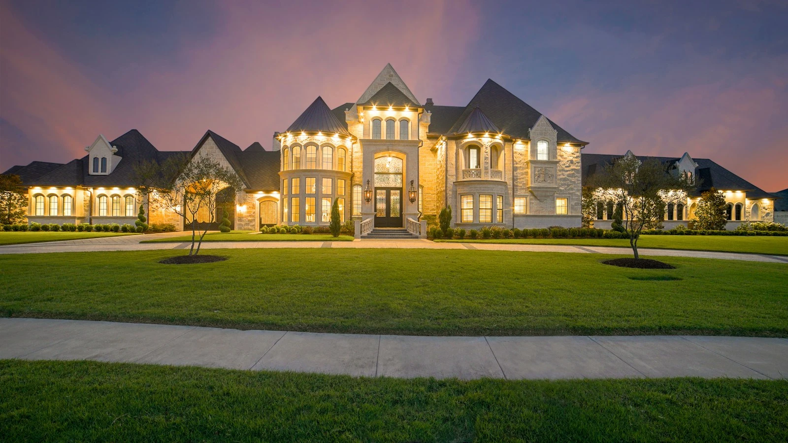 Development application 3D render: a substantial residence lit across its grounds at dusk