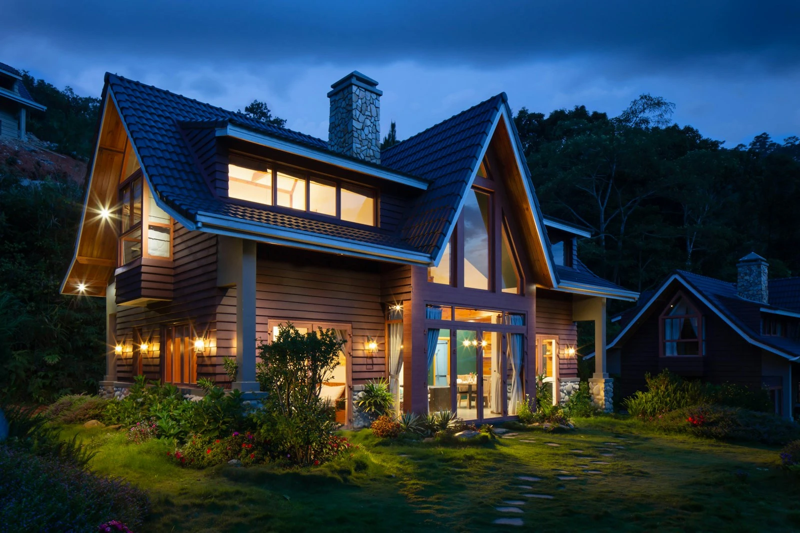 Timber and glass residence lit from within at night