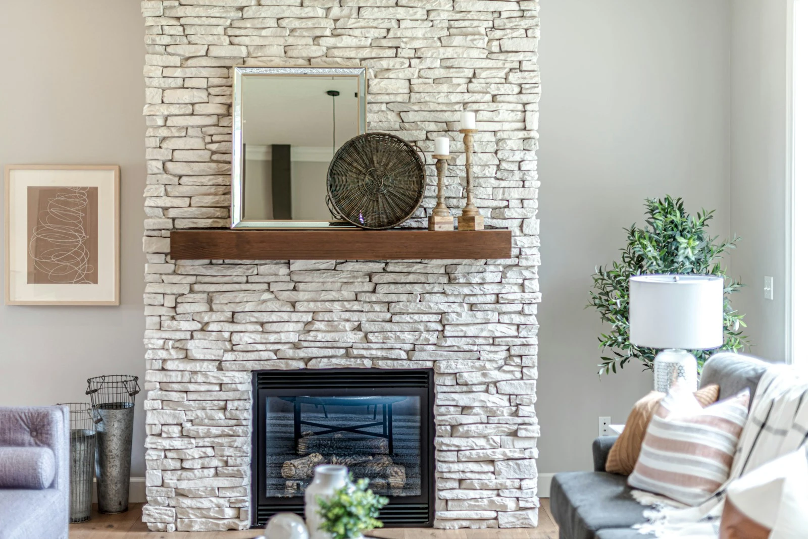 White brick fireplace styled with simple objects