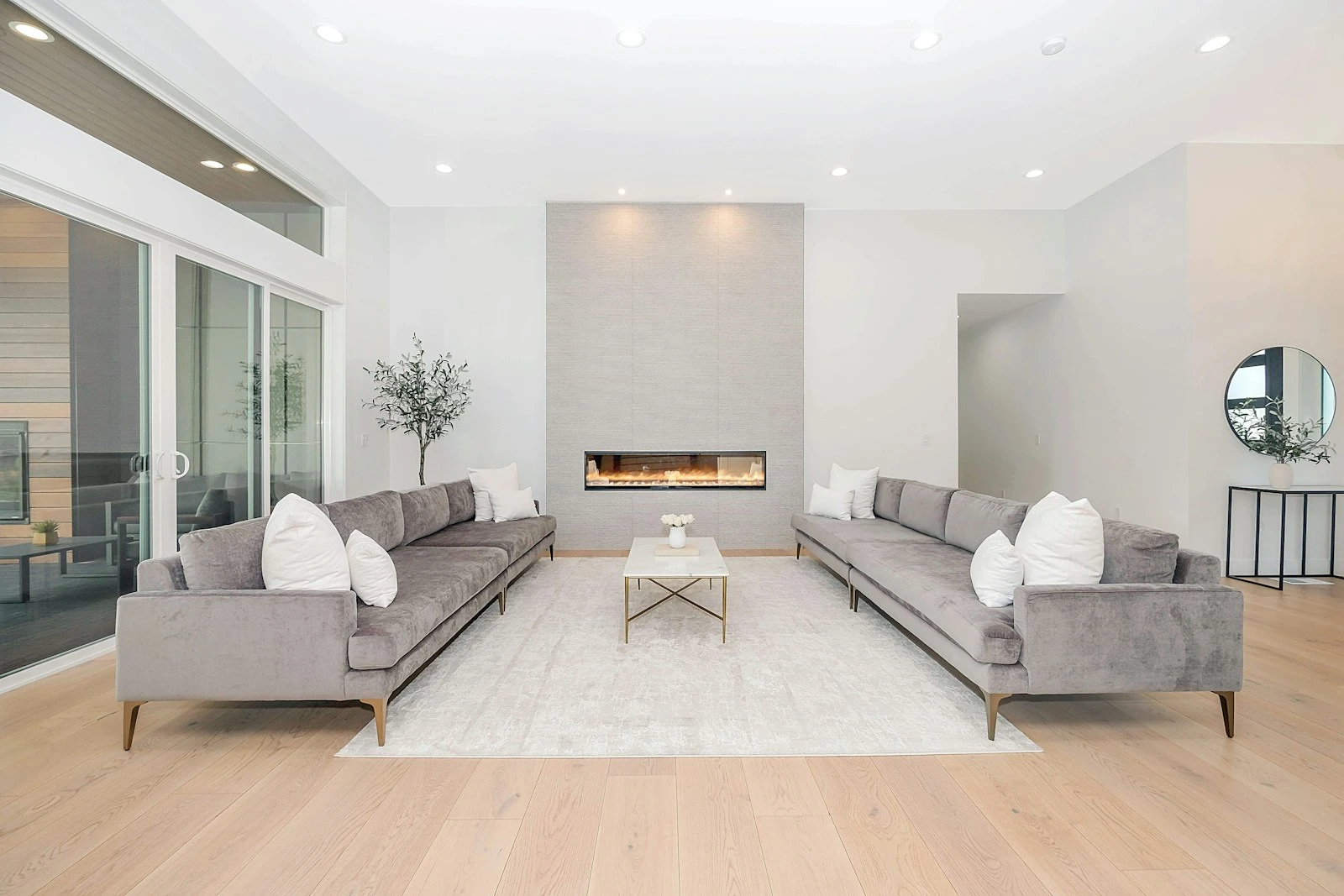 Bright white living room with a sculptural fireplace