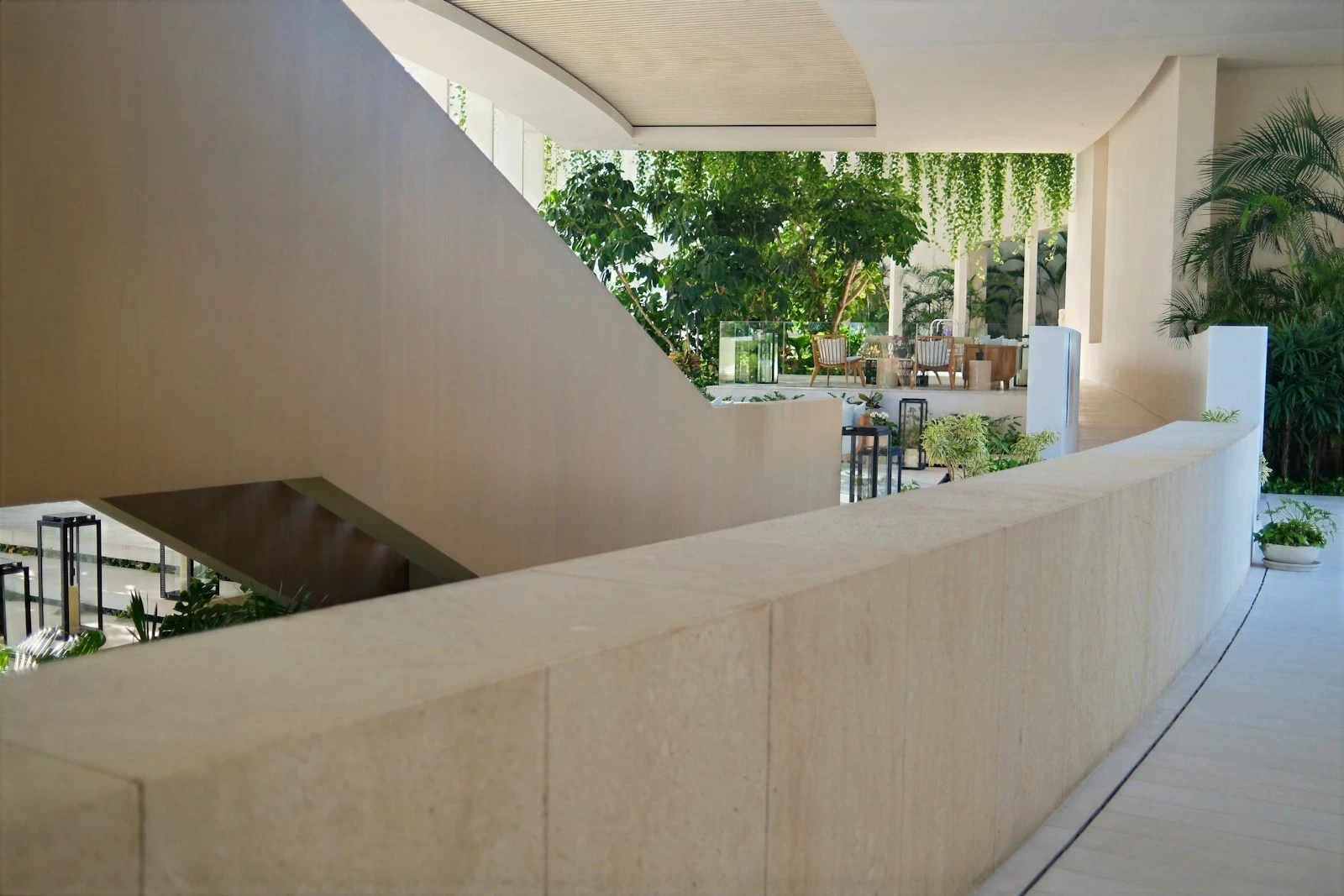 Sculptural white staircase rising through a light filled void