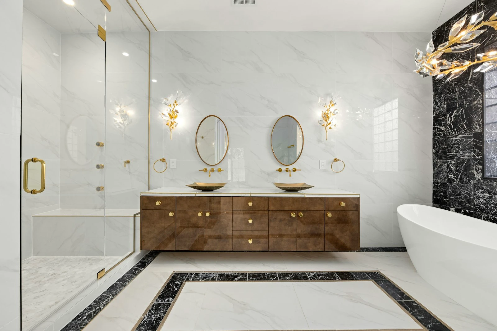 Marble bathroom with twin basins and arched mirrors