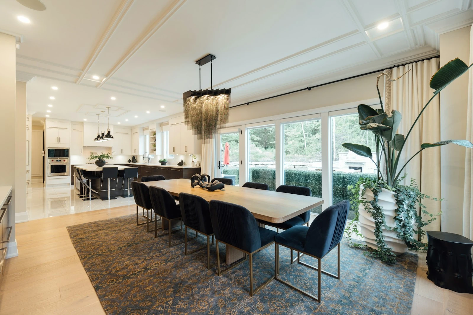 Dining space beneath a sculptural pendant